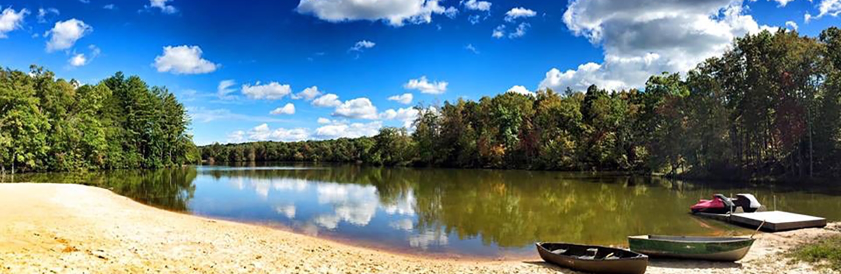 Panoramic shot from the beach looking onto the water at Lake Frances Retreats